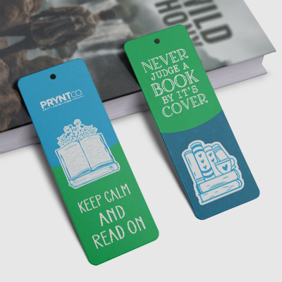 Blue and green custom bookmarks displayed on a desk